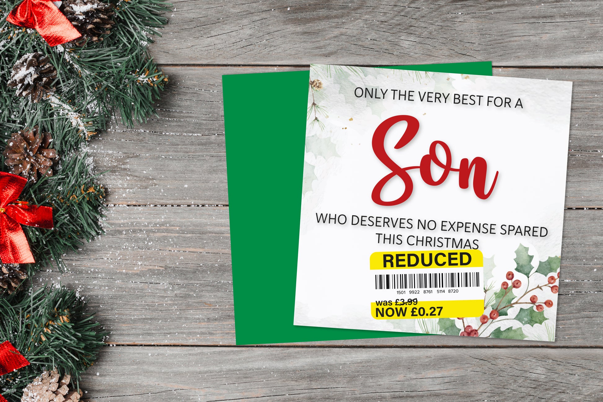 A greetings card on a blue background accompanied by flowers