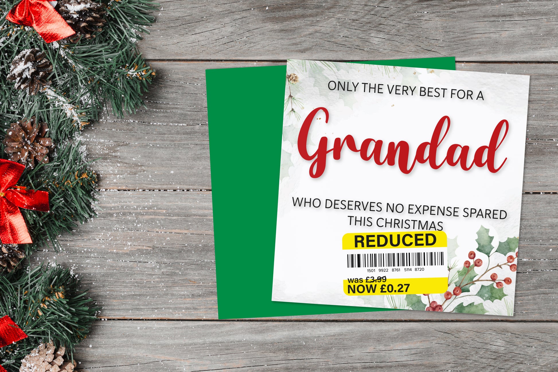 A greetings card on a blue background accompanied by flowers