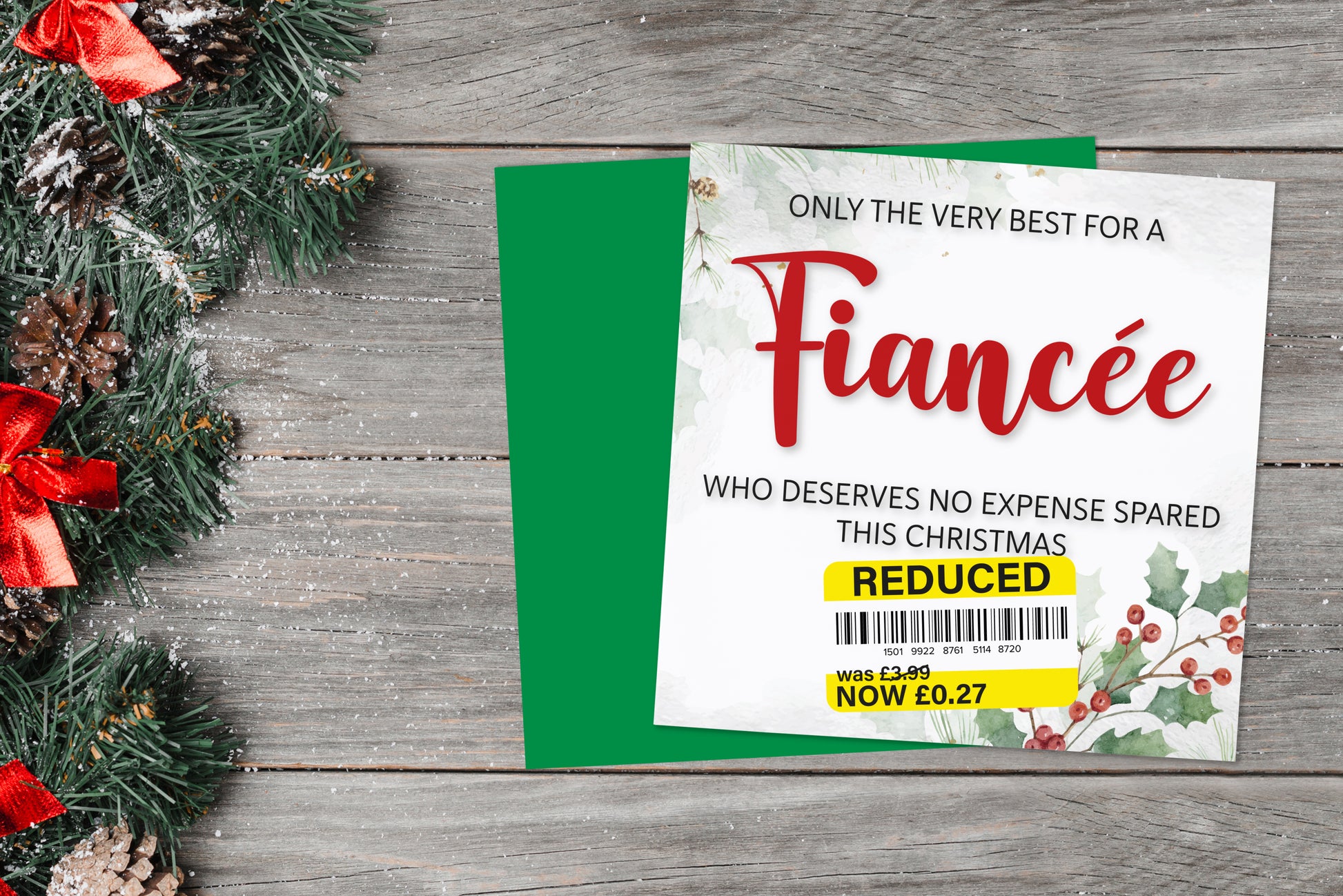 A greetings card on a blue background accompanied by flowers