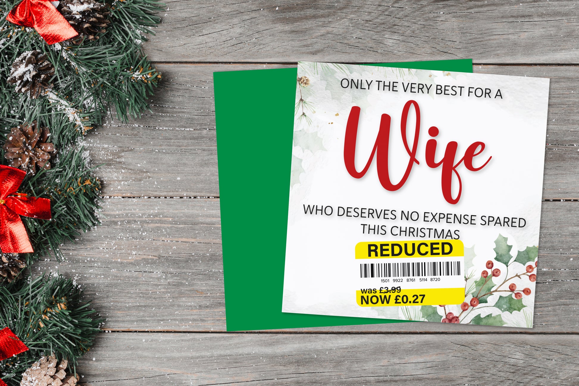 A greetings card on a blue background accompanied by flowers