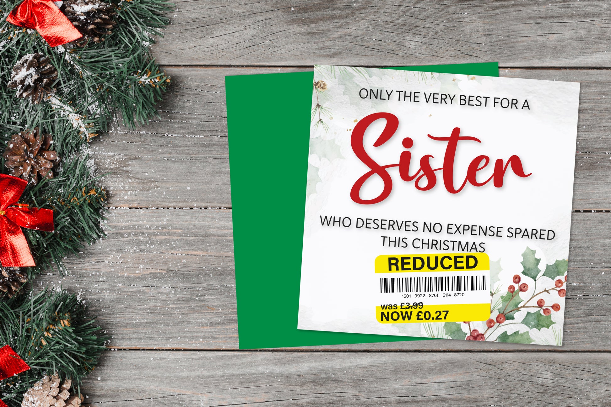 A greetings card on a blue background accompanied by flowers