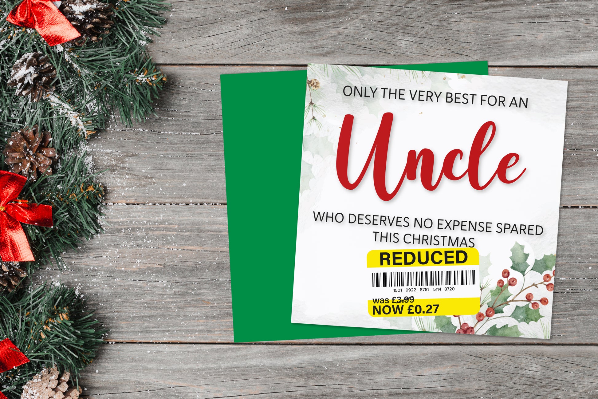 A greetings card on a blue background accompanied by flowers