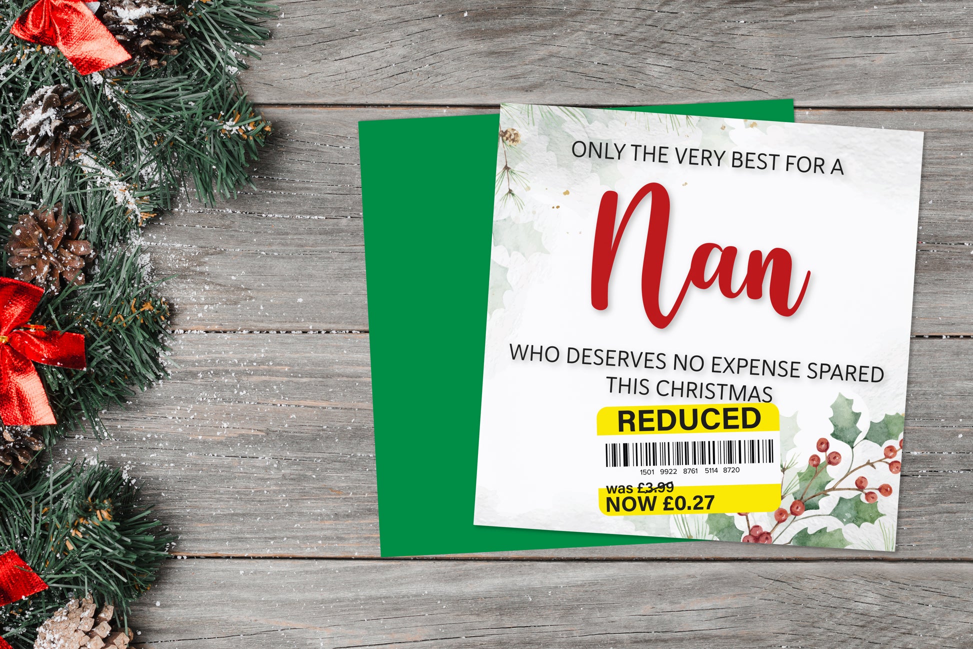 A greetings card on a blue background accompanied by flowers