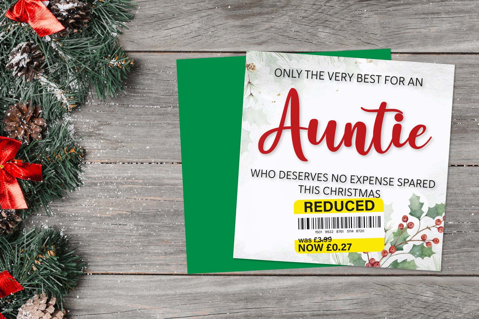 A greetings card on a blue background accompanied by flowers