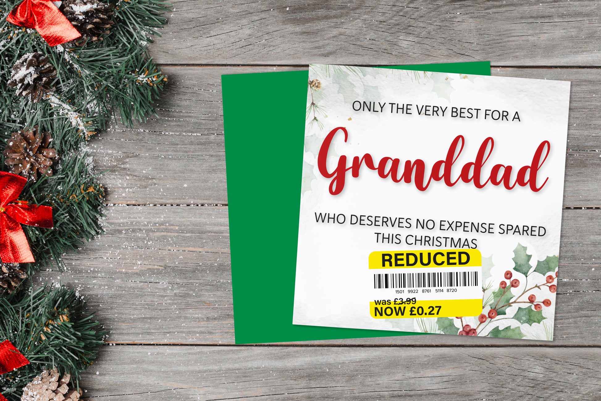 A greetings card on a blue background accompanied by flowers