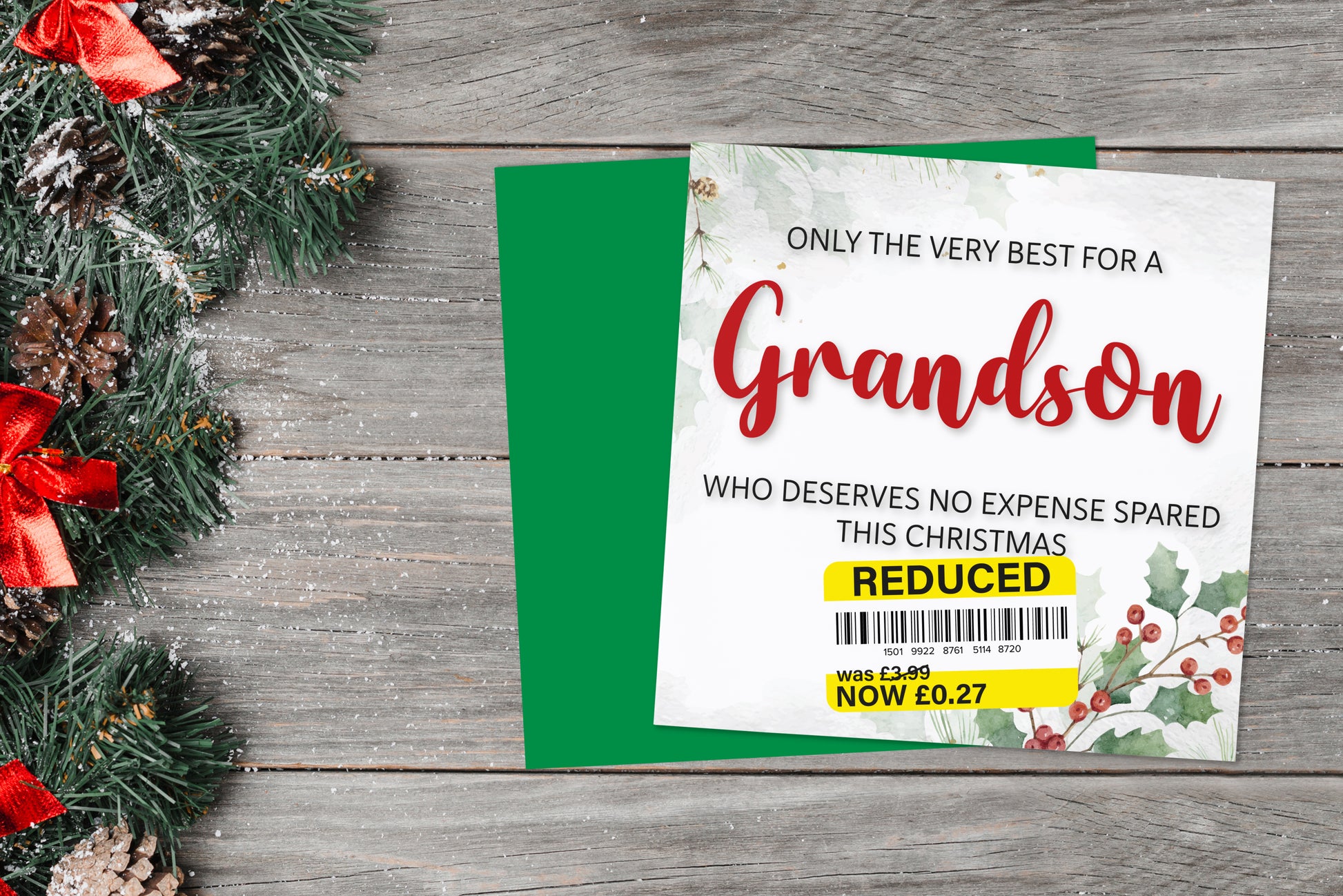 A greetings card on a blue background accompanied by flowers