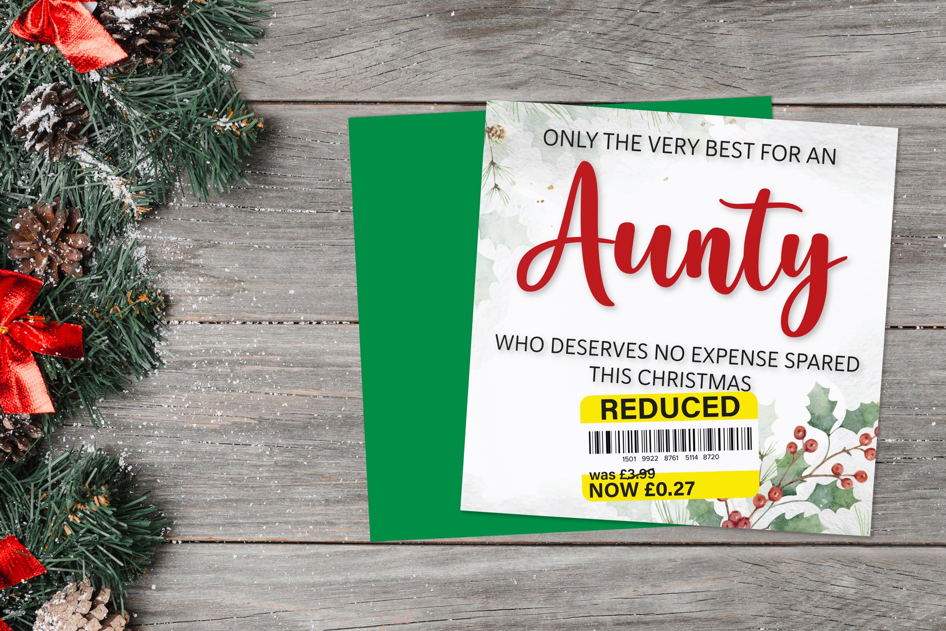 A greetings card on a blue background accompanied by flowers