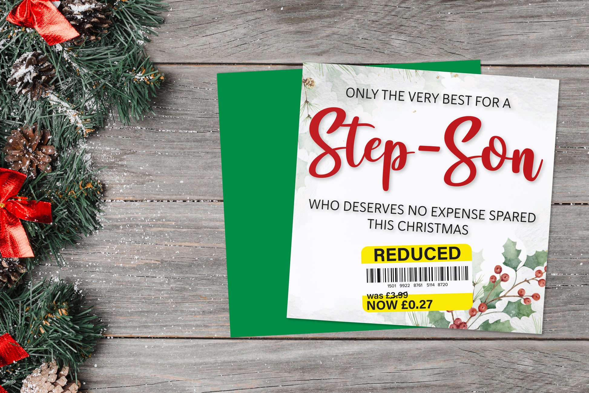 A greetings card on a blue background accompanied by flowers