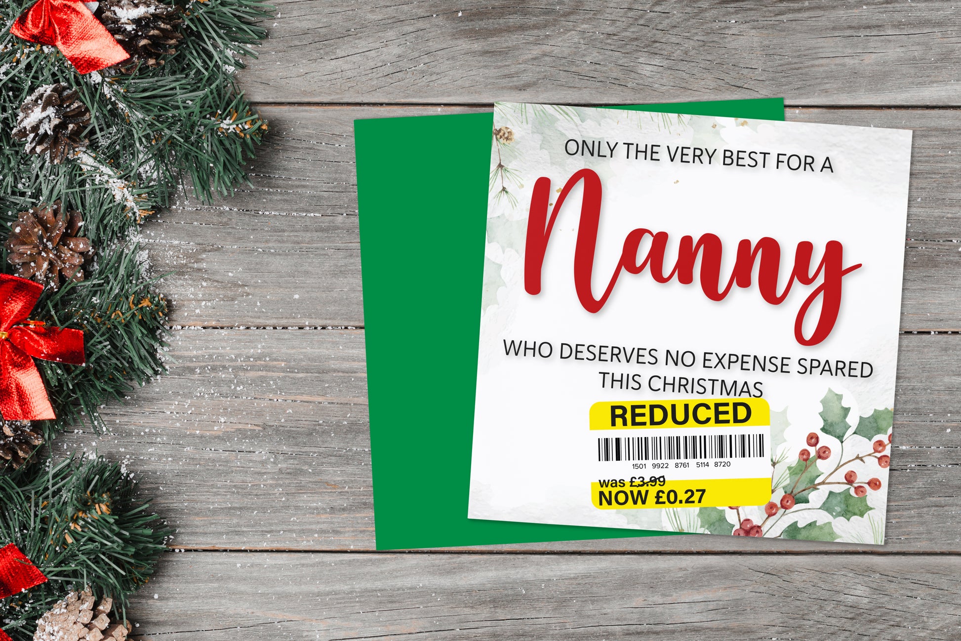 A greetings card on a blue background accompanied by flowers