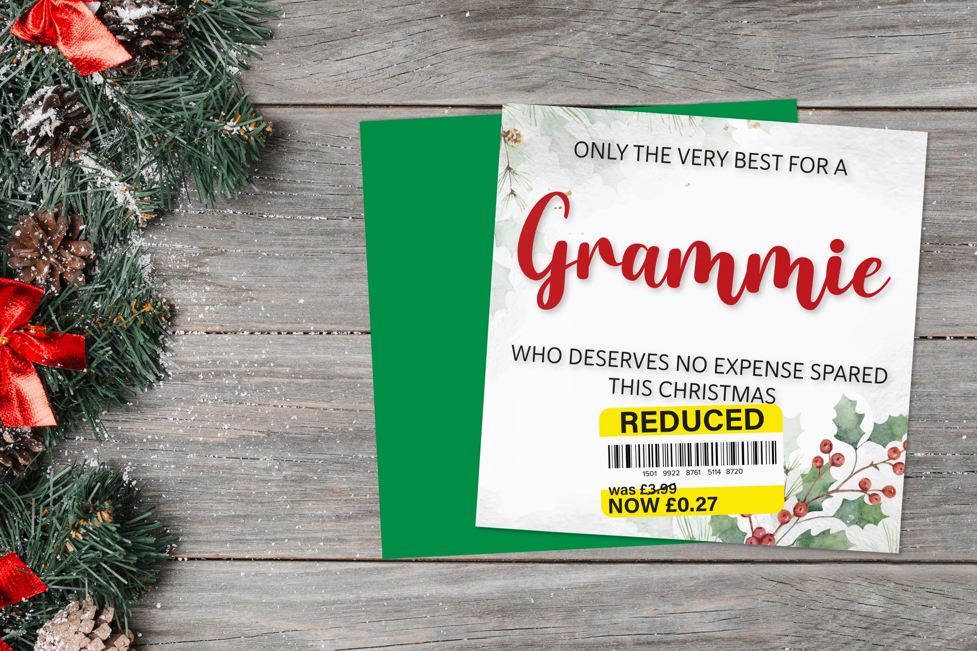 A greetings card on a blue background accompanied by flowers