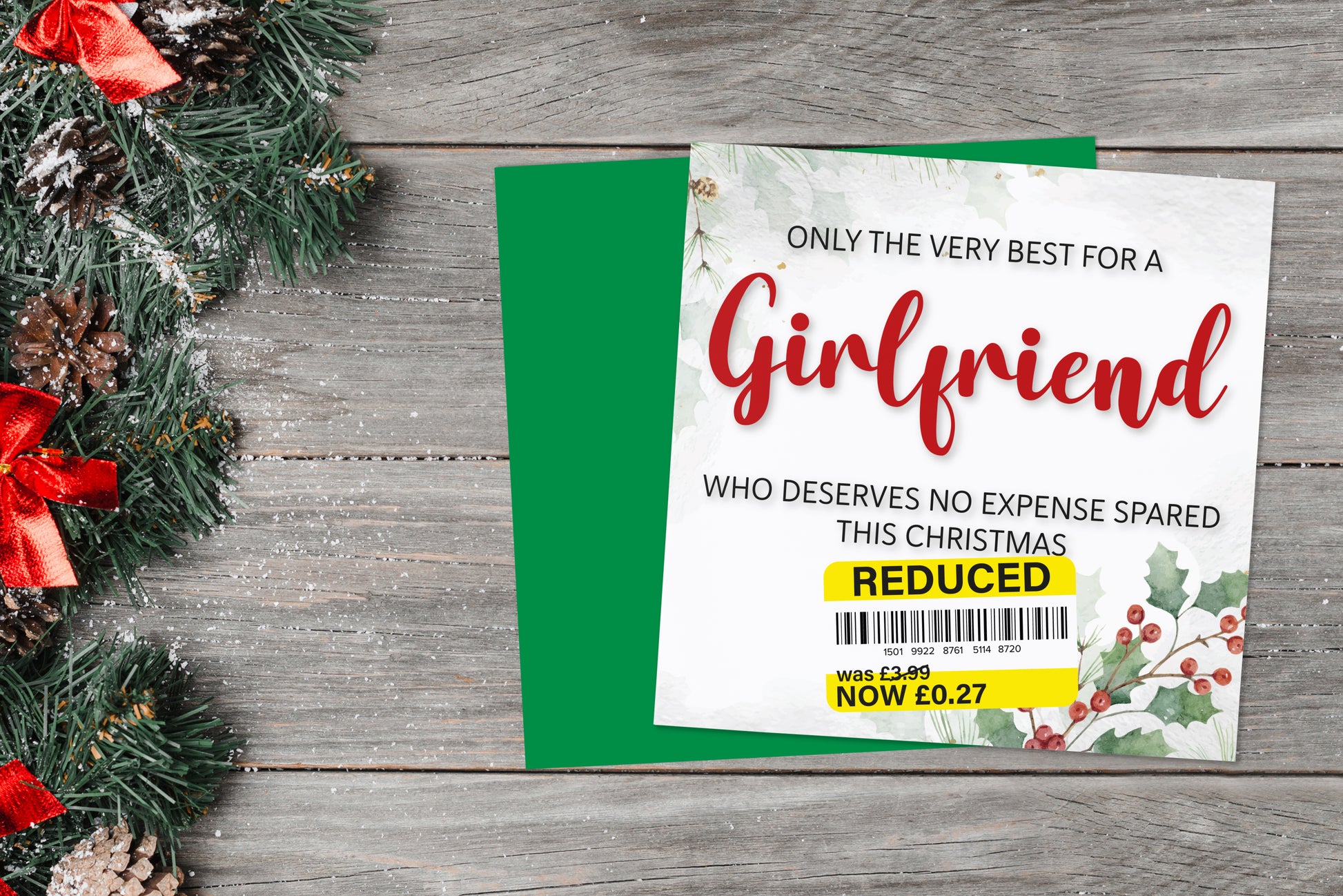 A greetings card on a blue background accompanied by flowers