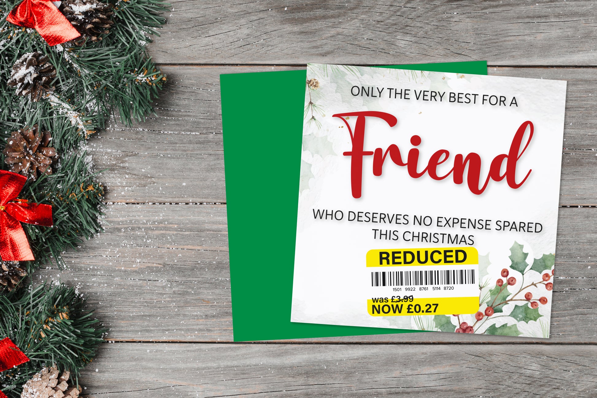 A greetings card on a blue background accompanied by flowers