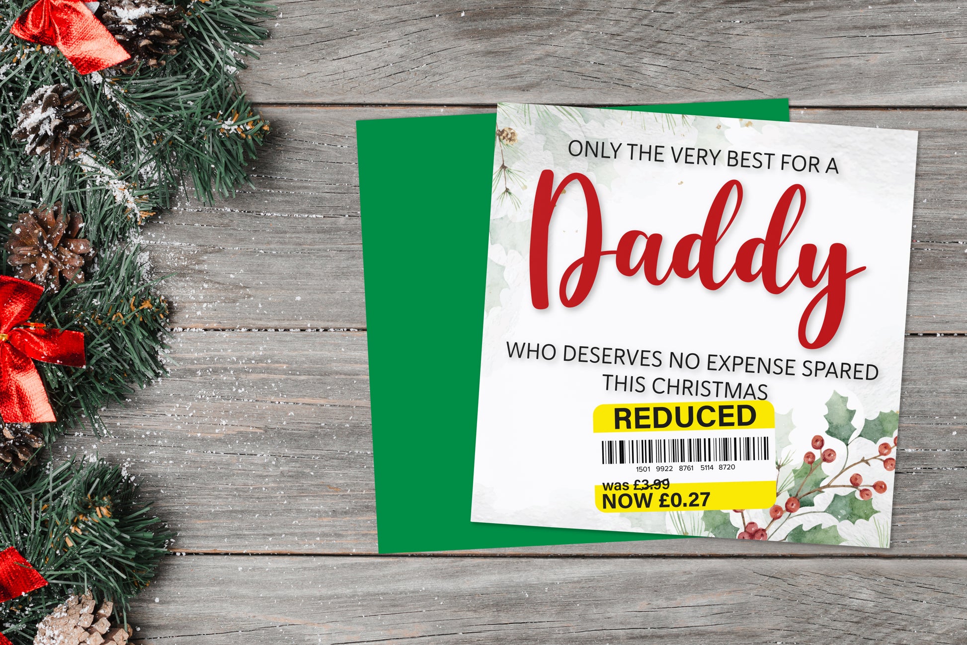 A greetings card on a blue background accompanied by flowers