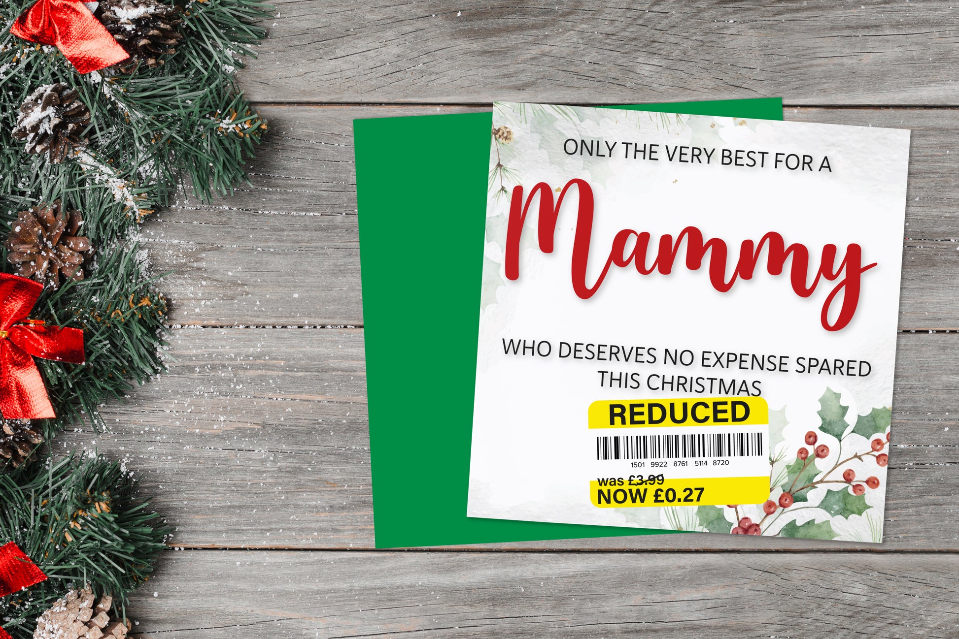 A greetings card on a blue background accompanied by flowers