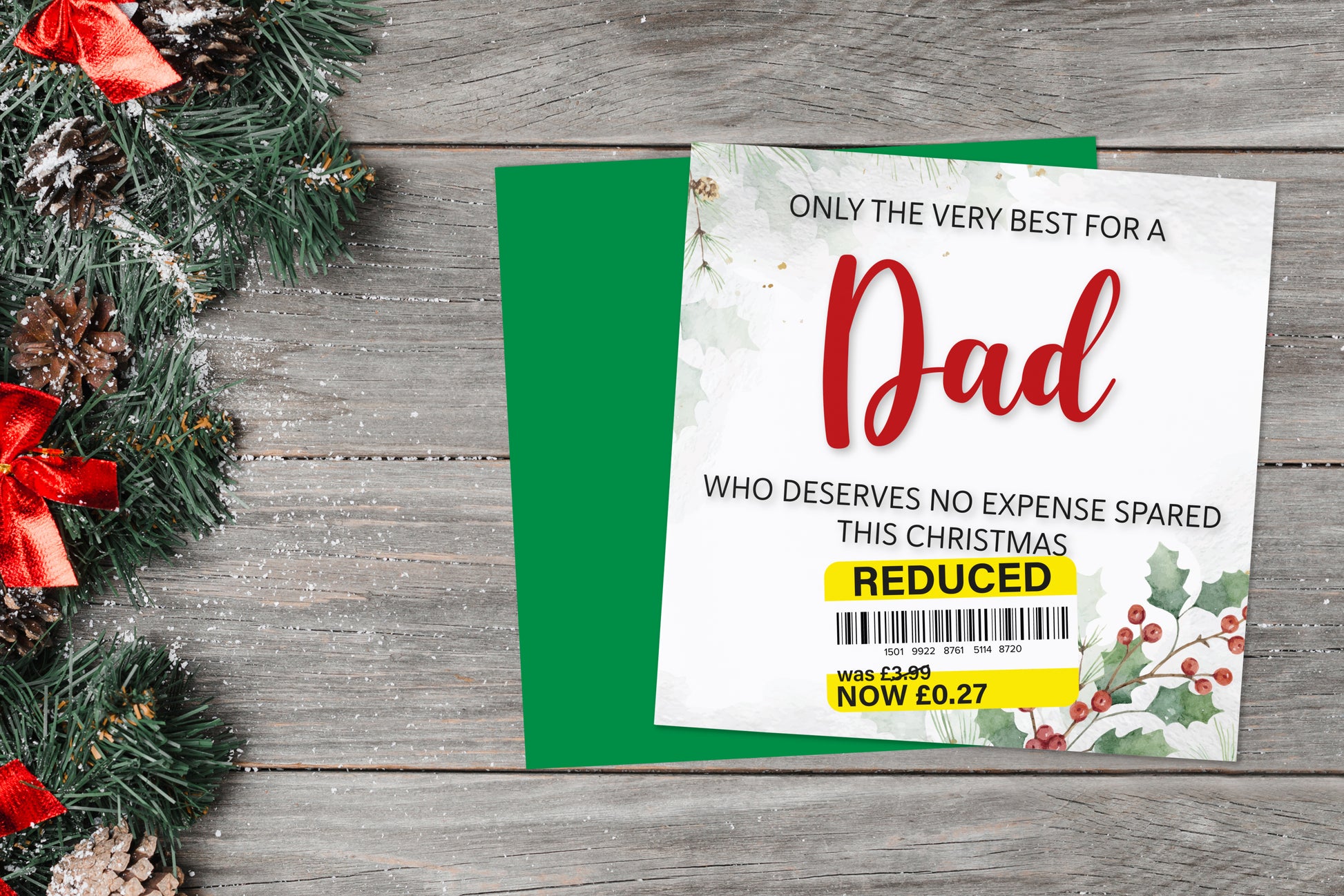 A greetings card on a blue background accompanied by flowers