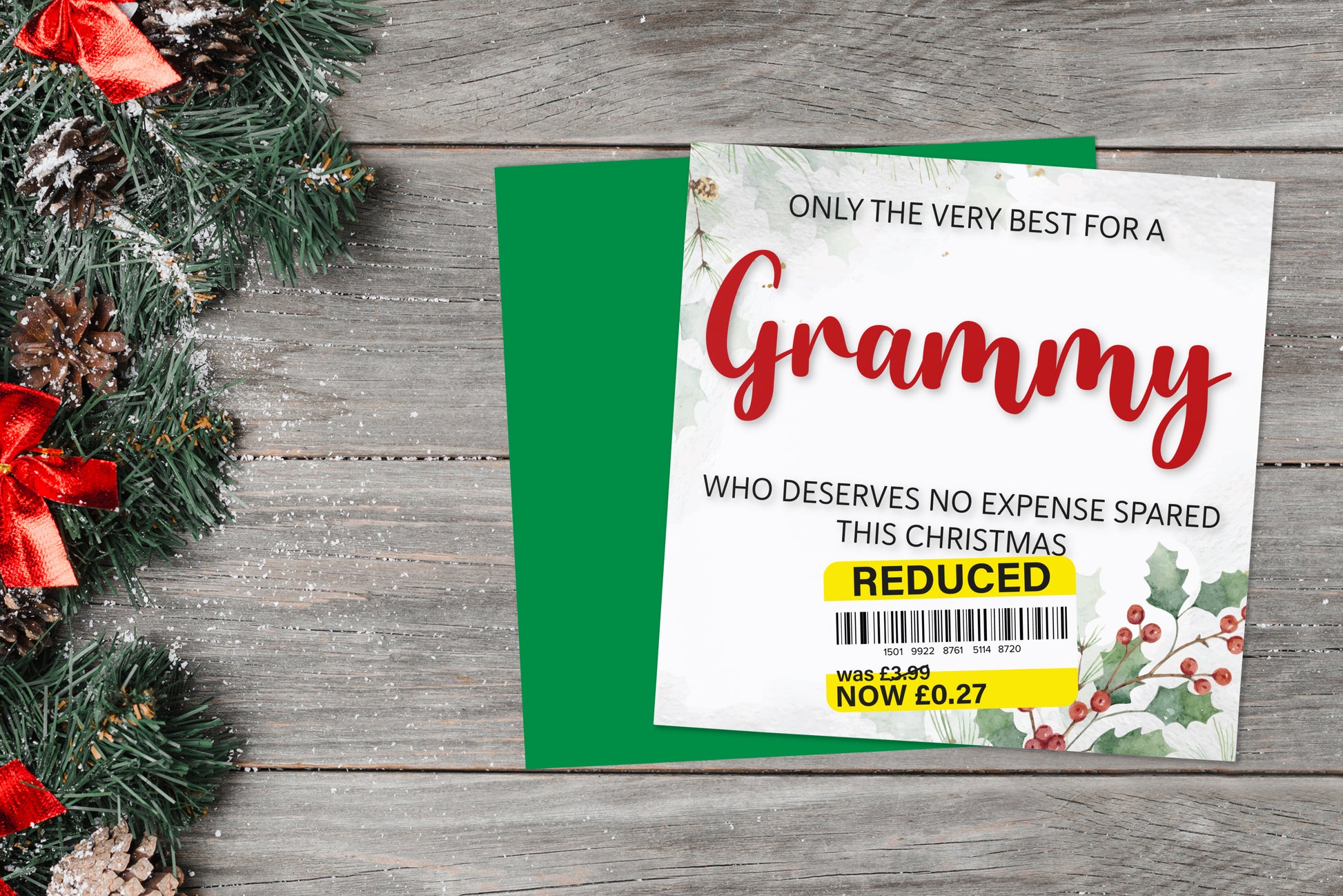 A greetings card on a blue background accompanied by flowers