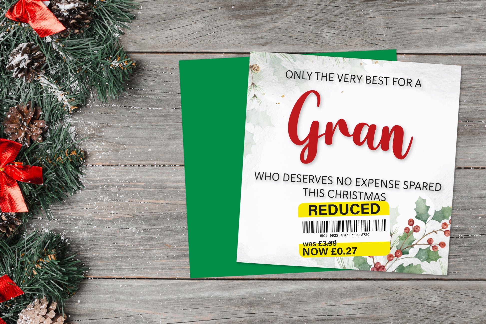 A greetings card on a blue background accompanied by flowers