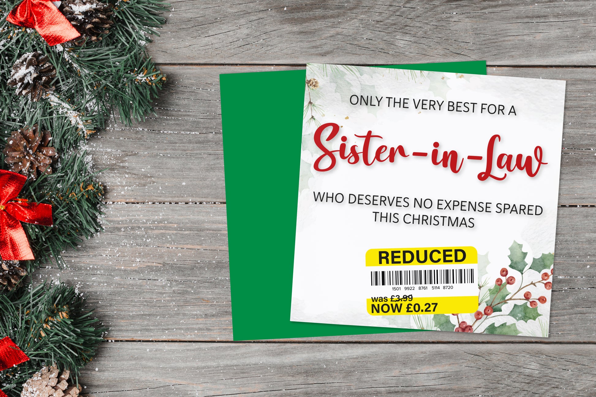 A greetings card on a blue background accompanied by flowers