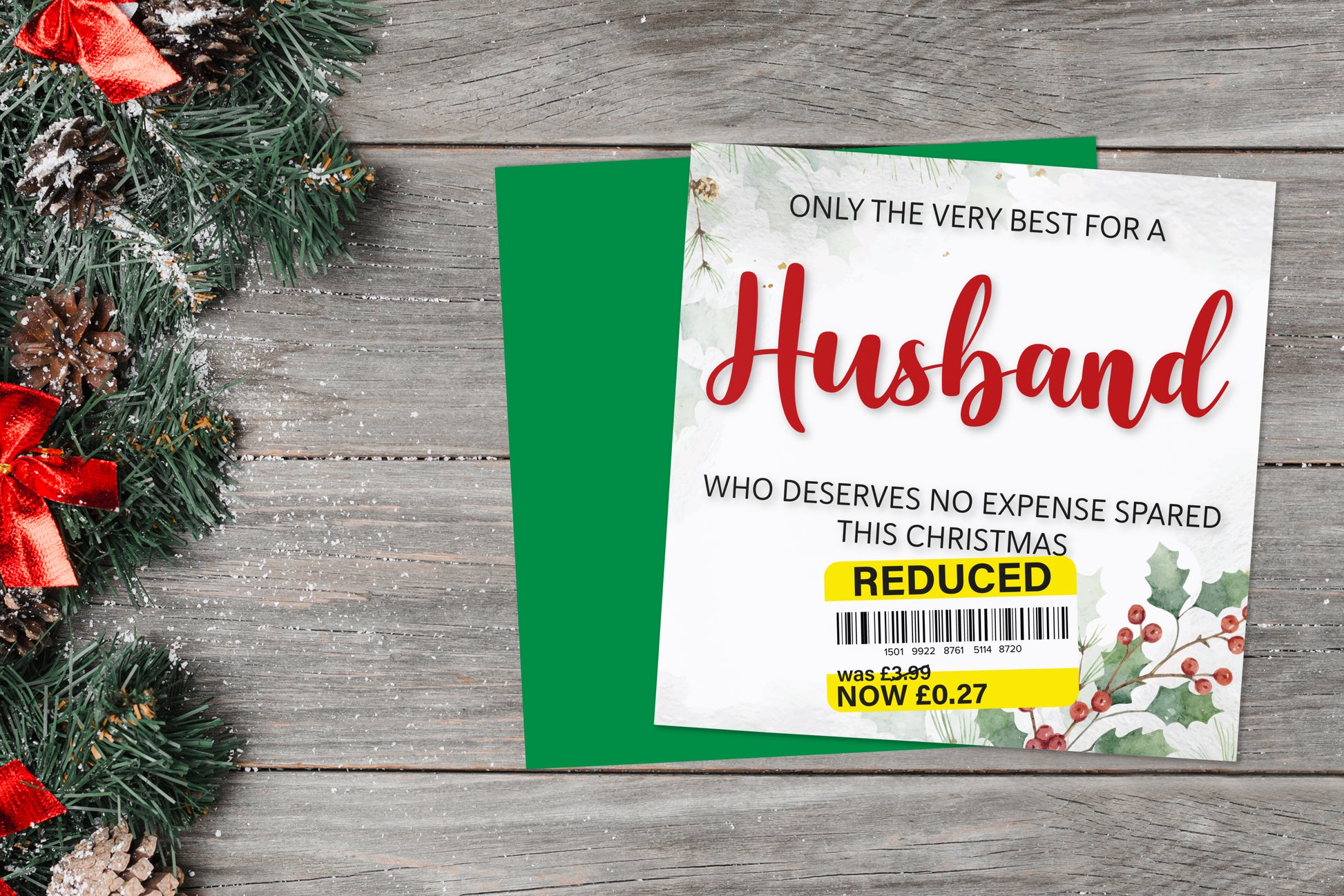 A greetings card on a blue background accompanied by flowers