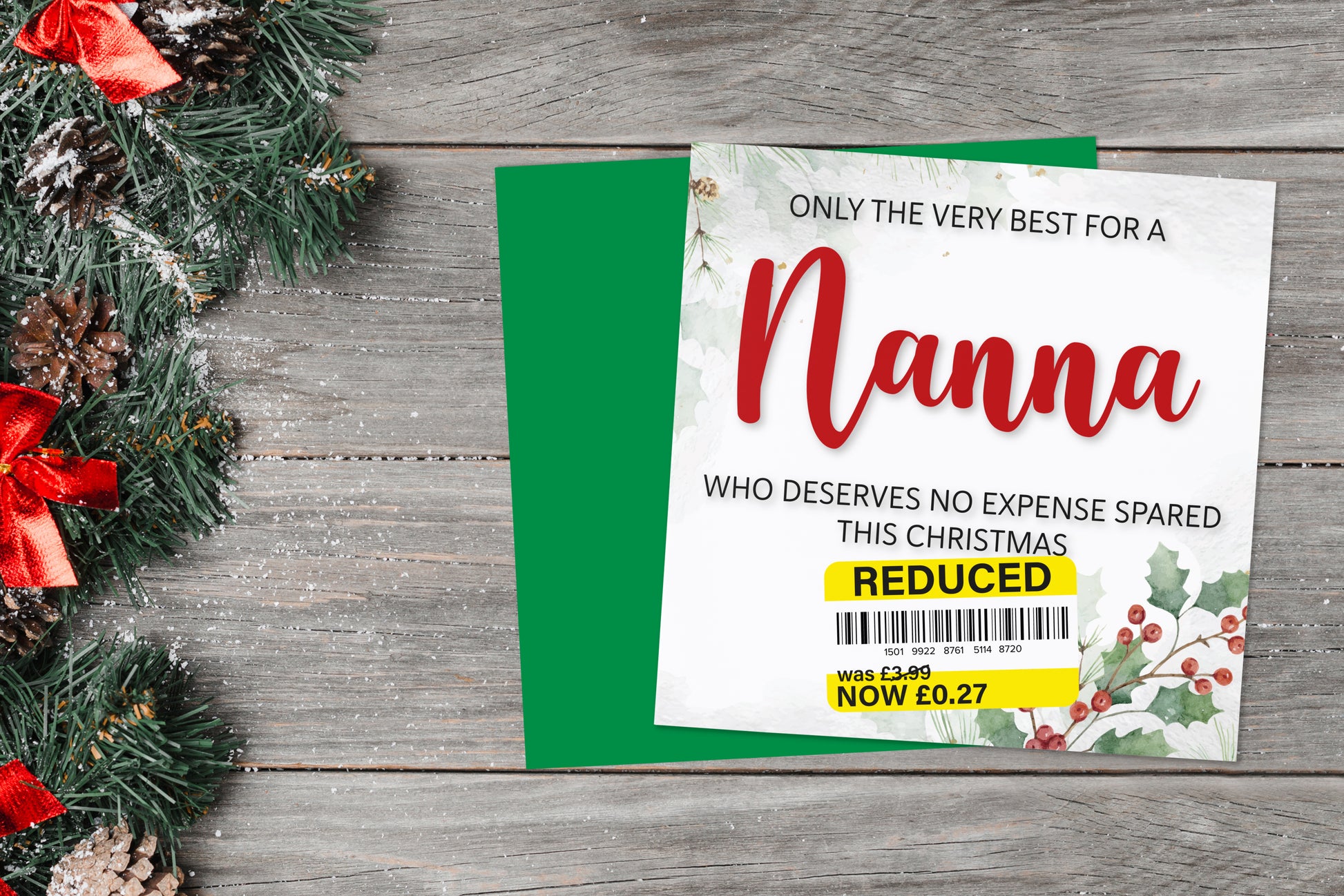 A greetings card on a blue background accompanied by flowers