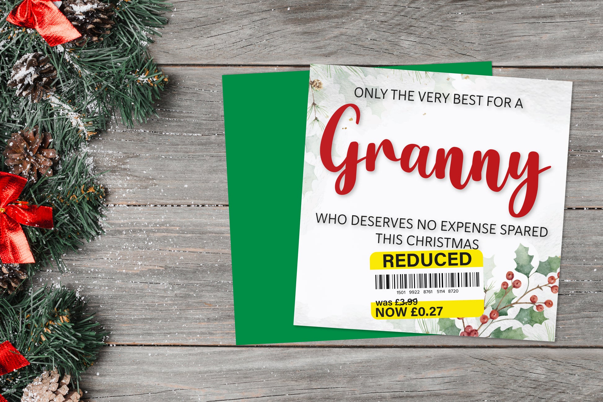 A greetings card on a blue background accompanied by flowers